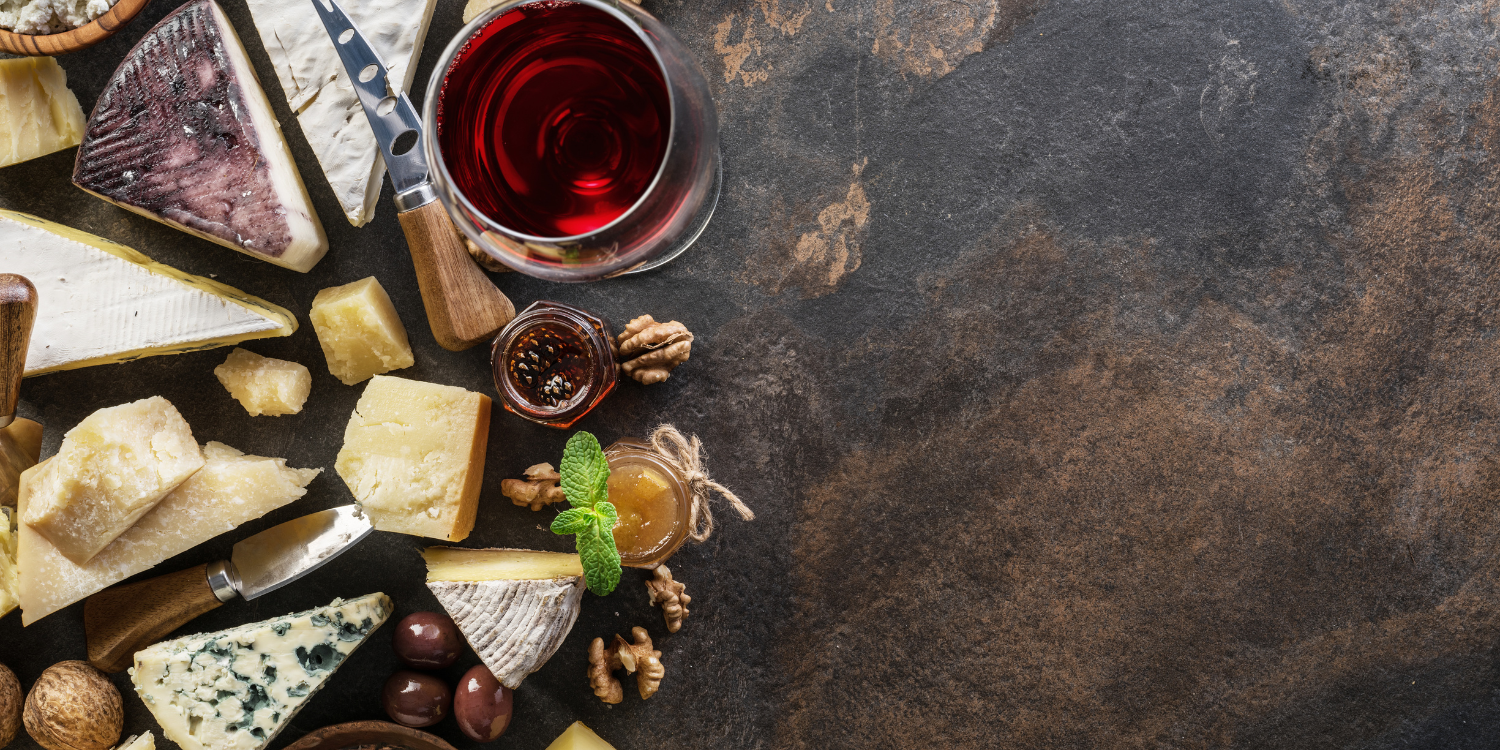 wine and cheese on a clean brown background